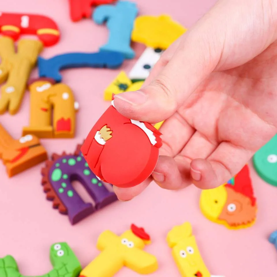 Close-up of a red character letter from the animal alphabet PVC toy set held by hand