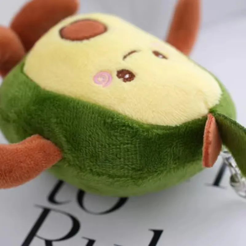 Side view of avocado plush keychain showing body thickness, side seam, and small limb placement