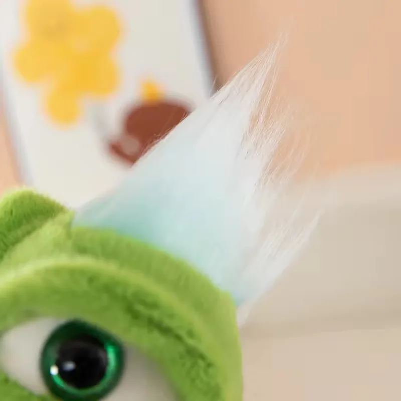 Close-up of the dinosaur plush head crest with pale blue and white fabric detail