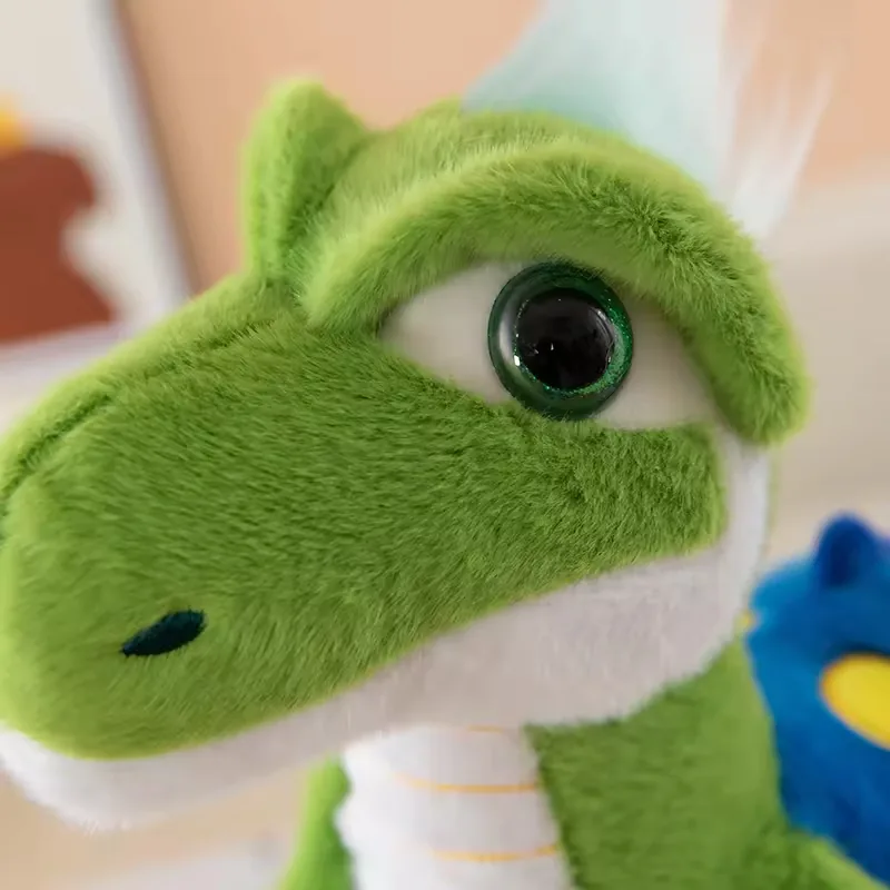 Close-up of green dinosaur plush face with glossy eye, rounded snout, and white jaw line