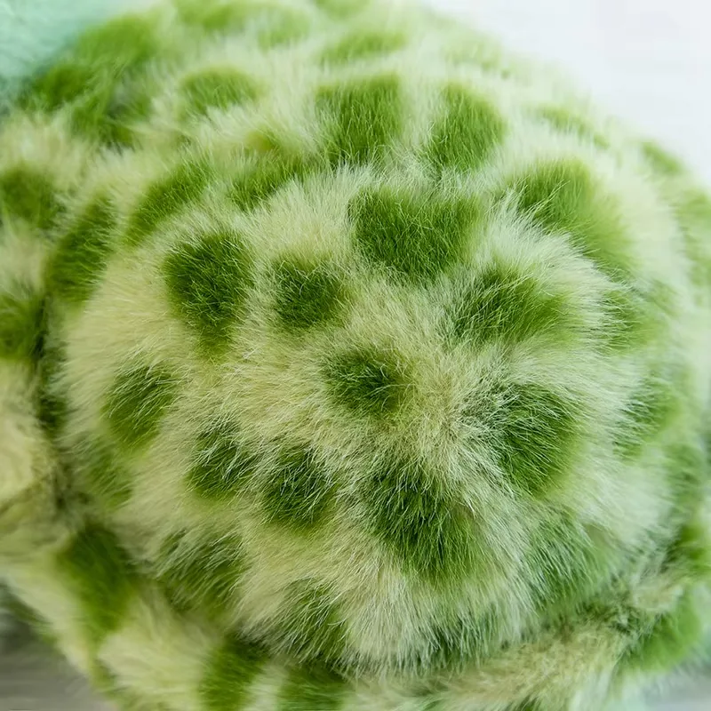 Close-up of the turtle plush shell with a fuzzy green spotted pattern