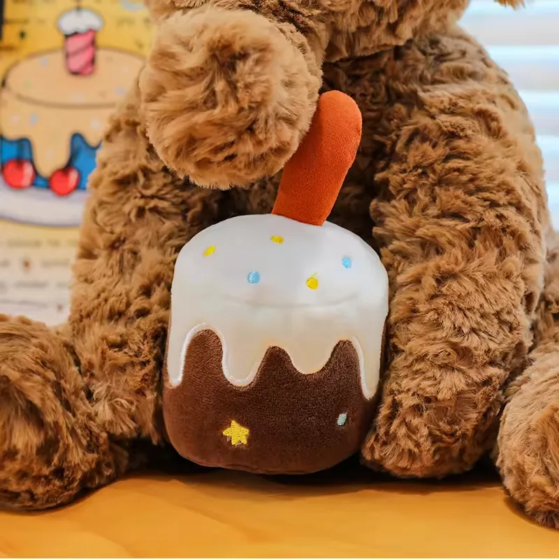 Birthday cake accessory held between the elephant plush doll's front legs