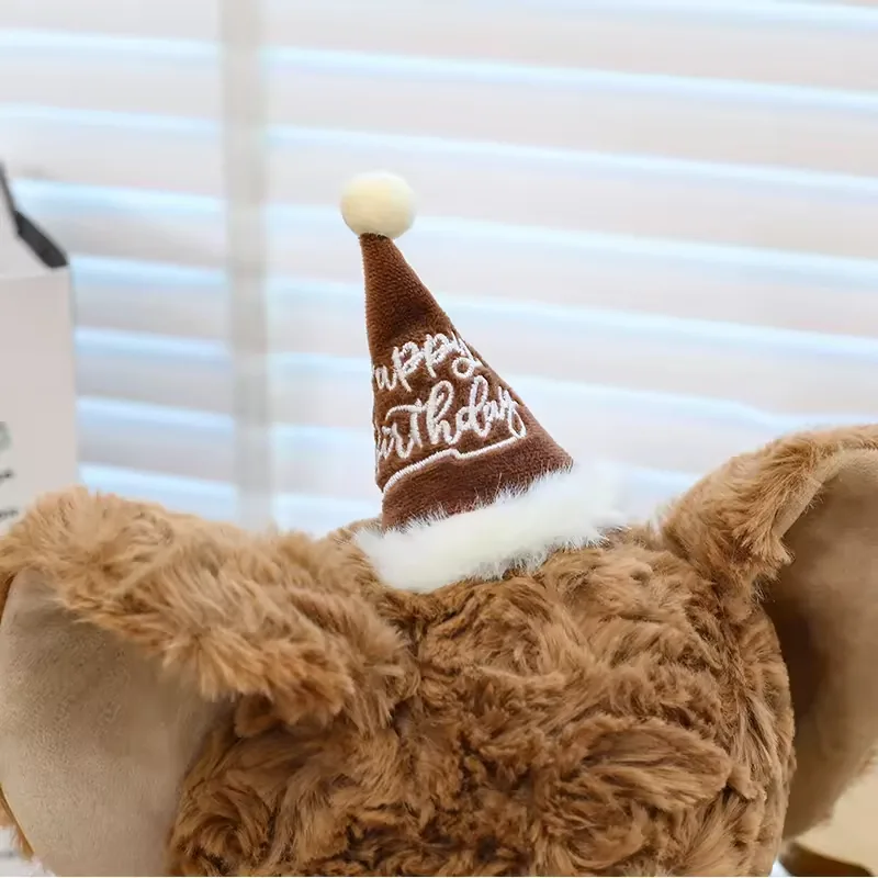 Close detail of the brown birthday party hat on the elephant plush head