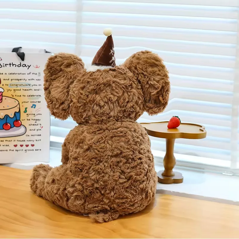 Back view of brown birthday elephant plush doll showing rounded body and oversized ear shape