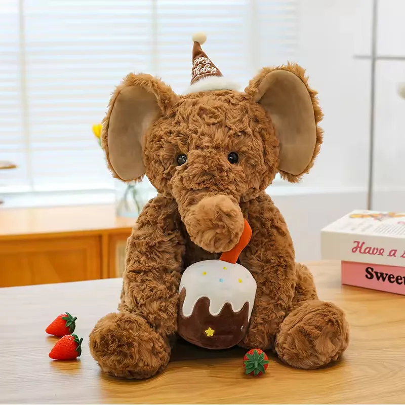 Brown birthday elephant plush doll seated upright with birthday cake accessory and strawberry props