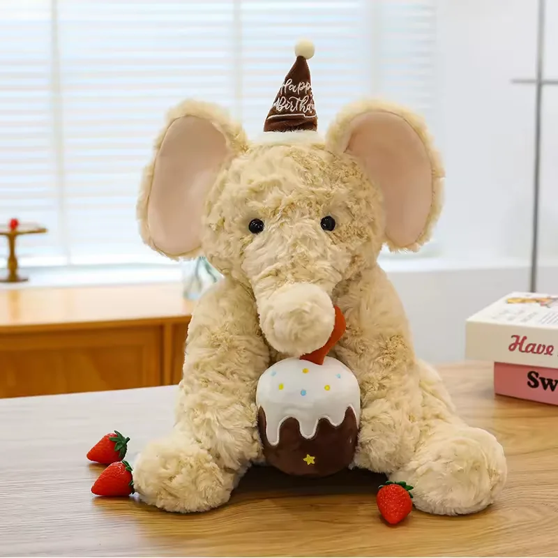Cream birthday elephant plush doll with soft pink ears, brown party hat, and cake accessory