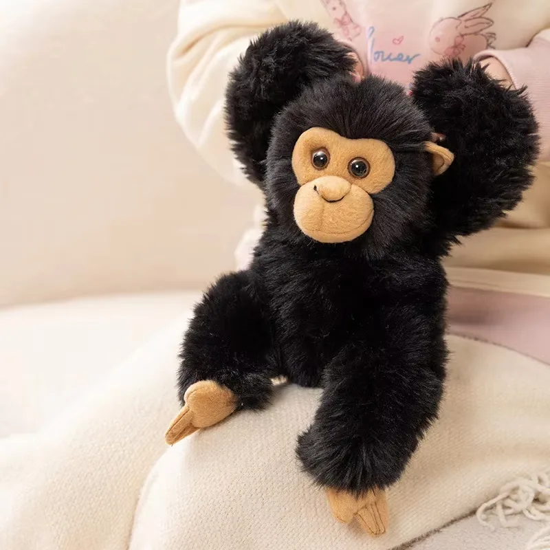 Black chimpanzee plush doll seated with a model for scale and zoo-gift merchandising reference