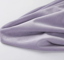Lavender minky fabric draped in soft folds to show a denser and smoother plush hand feel