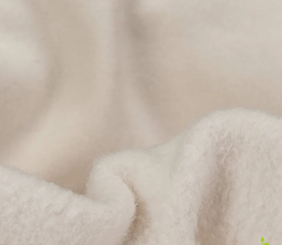 Cream sherpa fabric close-up showing a softer fleece texture at shorter viewing distance