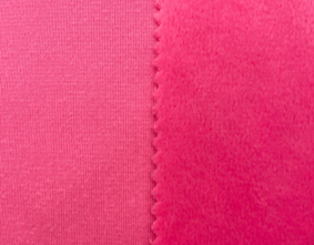 Close-up of pink velboa showing the plush face, reverse side, and seam edge for backing comparison