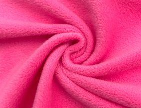 Pink short-pile velboa fabric swirled into a spiral to show a smooth, low-profile plush surface
