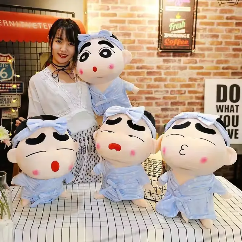 Four Crayon Shin-chan pajama plush dolls grouped together to show surprised, sleepy, and kiss-face expressions in one coordinated collection