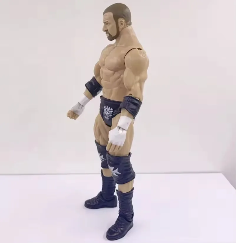 Left-profile view of an articulated wrestling-style action figure showing arm cuts, chest depth, and tall lace-up boots