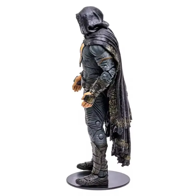 Left-side profile of a hooded PVC action figure showing cape drape, shoulder armor, and body depth