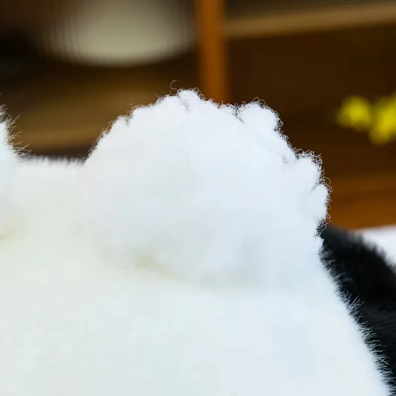 Soft white panda plush tail detail on the back of the seated body