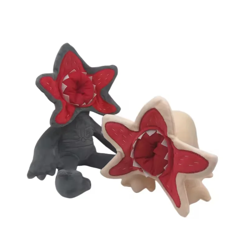 Grey Demogorgon plush doll and beige creature plush shown at an angle to compare face depth and body posture