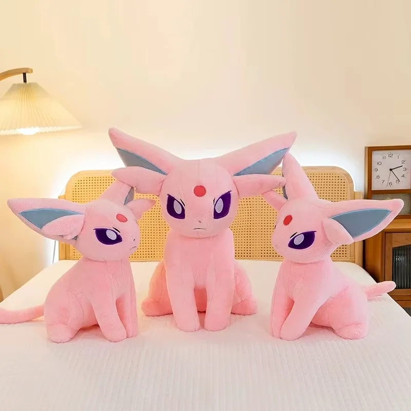 Three pink Espeon plush dolls displayed together as a size-based character collection