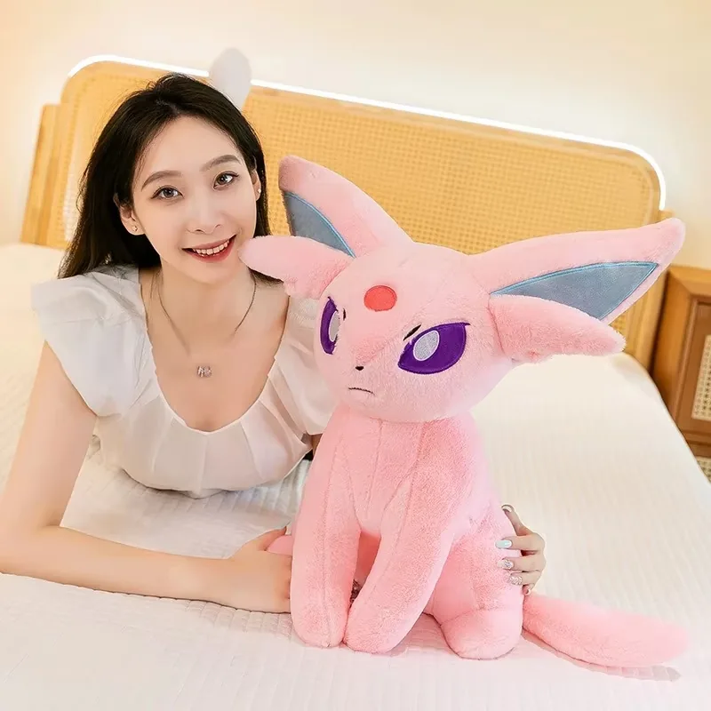 Model beside a large Espeon plush doll to show display scale and gift size
