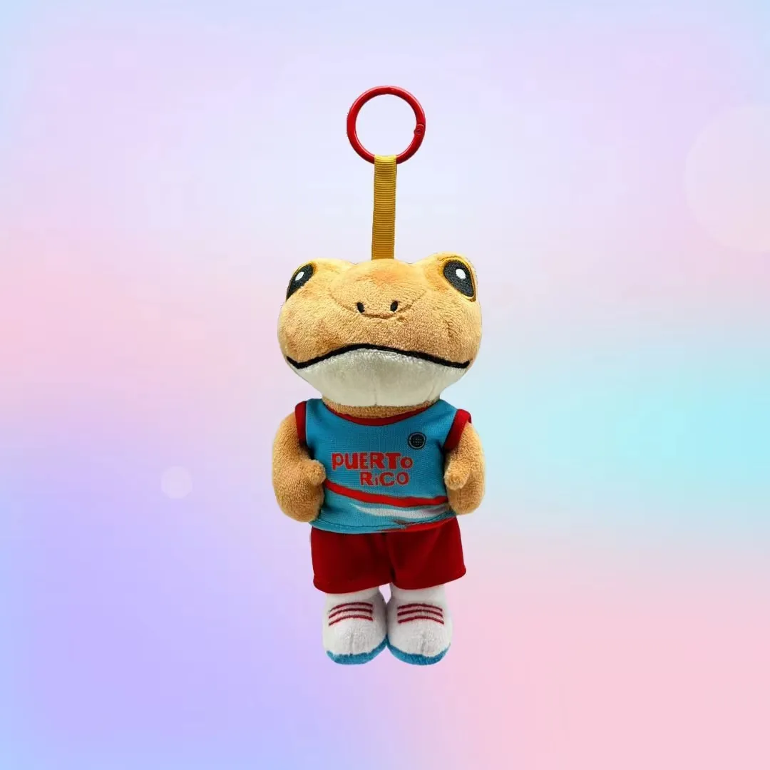 Frog plush keychain wearing a blue sports jersey, red shorts, and striped socks