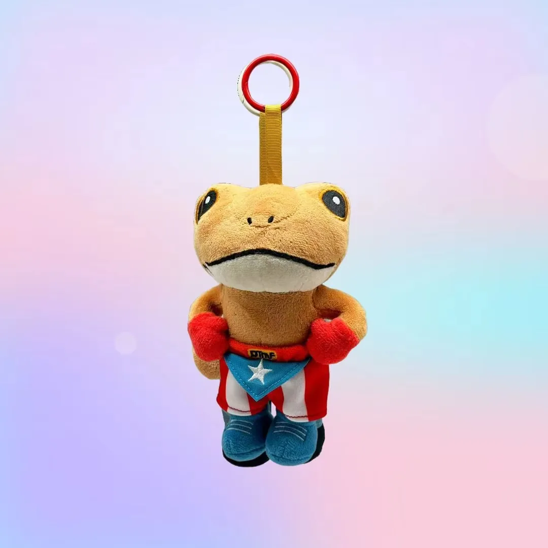 Frog plush keychain wearing a red superhero cape and blue scarf with a star emblem