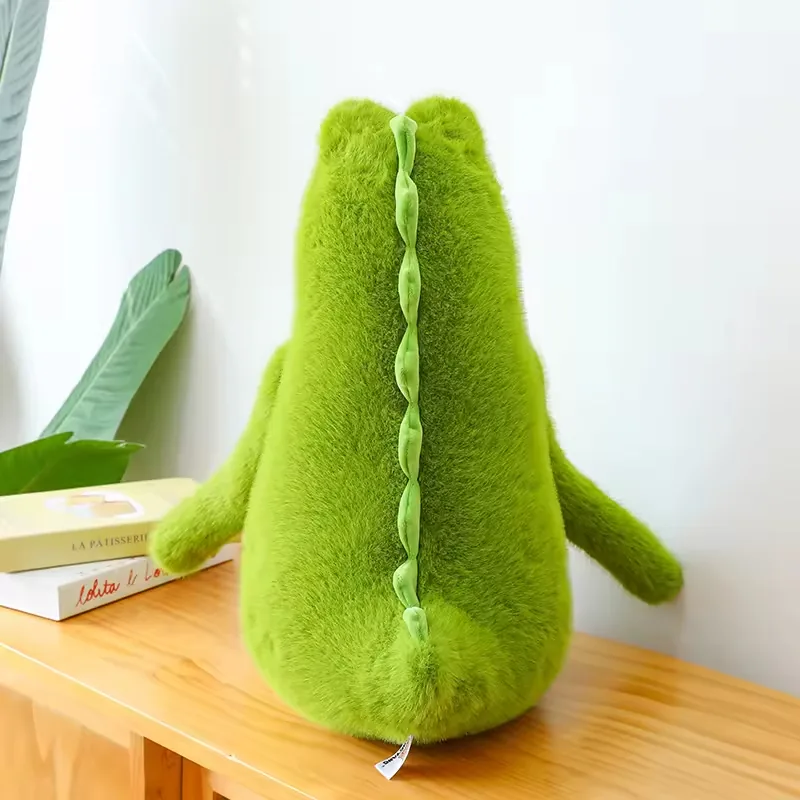Back view of the green crocodile plush doll showing the soft ridge detail running down the spine