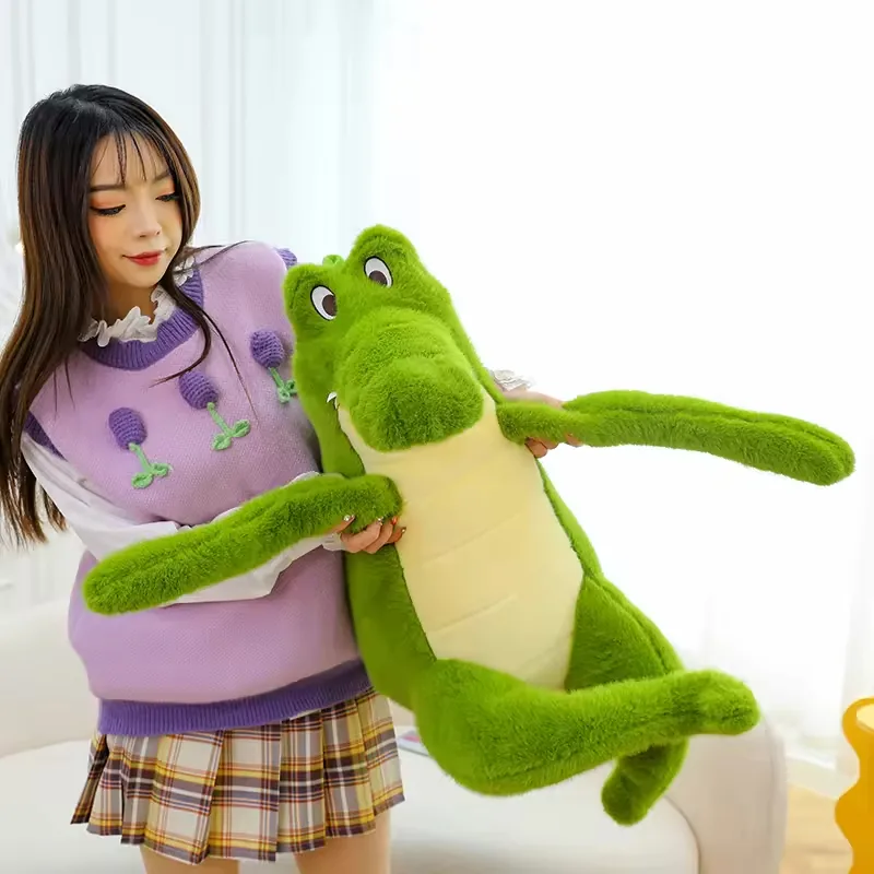 A person holding a large green crocodile plush doll to show oversized body scale and long soft limbs