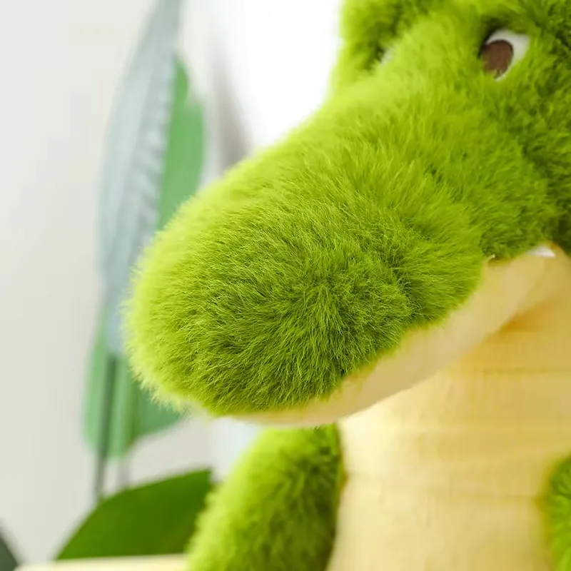 Close-up of the green crocodile plush snout with soft fur texture, raised eyes, and small white teeth