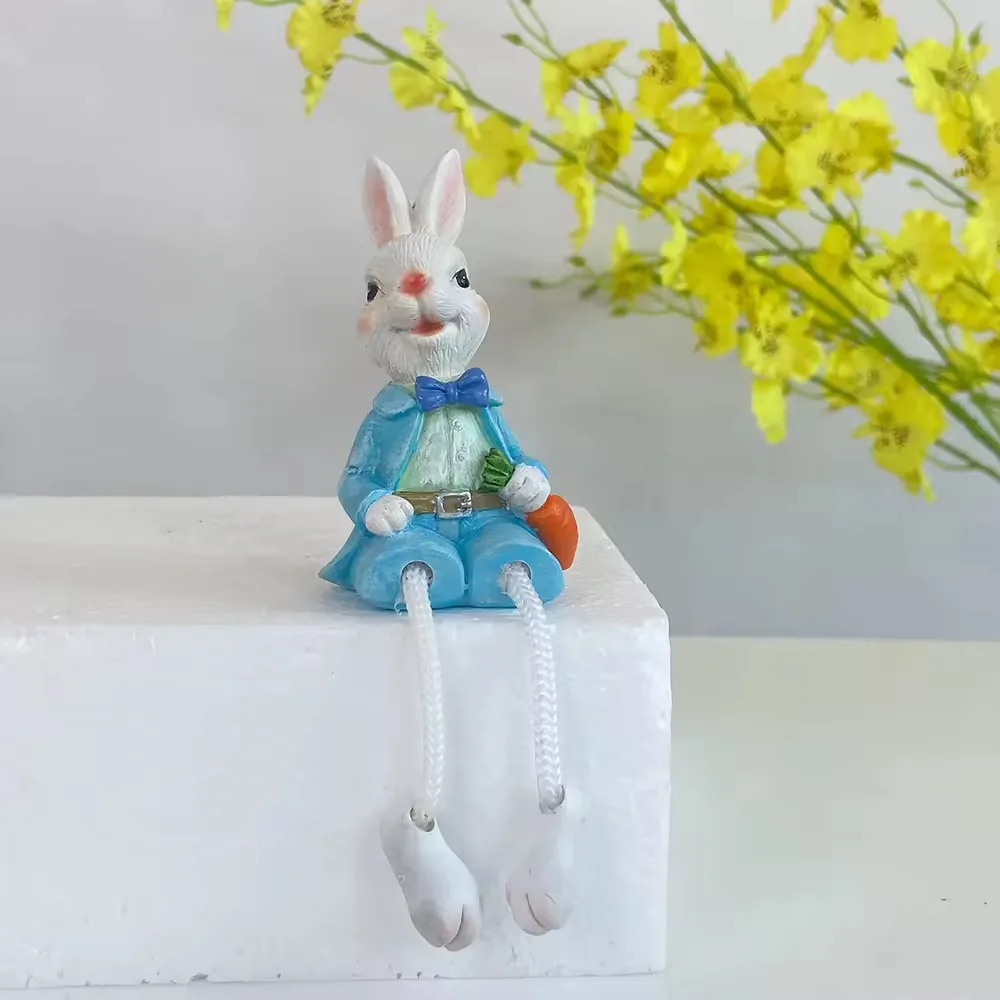 Hand-painted resin rabbit shelf sitter in a blue outfit with dangling legs for tabletop and ledge styling