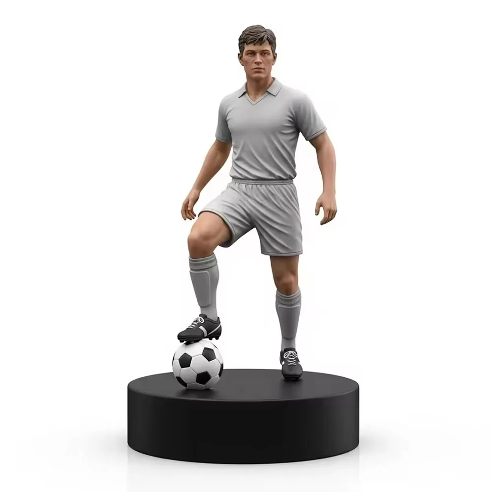 Hand-painted resin football player figurine in a gray kit posed on a black commemorative base