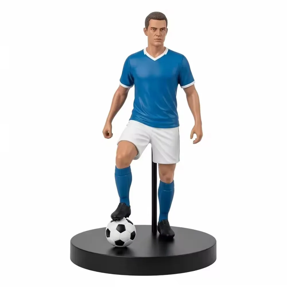 Resin football star commemorative figurine in a blue kit with a rear support stand on a black presentation base