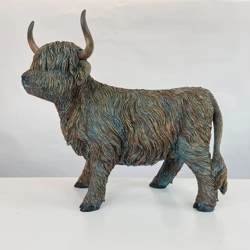 Side profile of a hand-painted resin Highland cow figurine showing full-body fur texture and tail detail