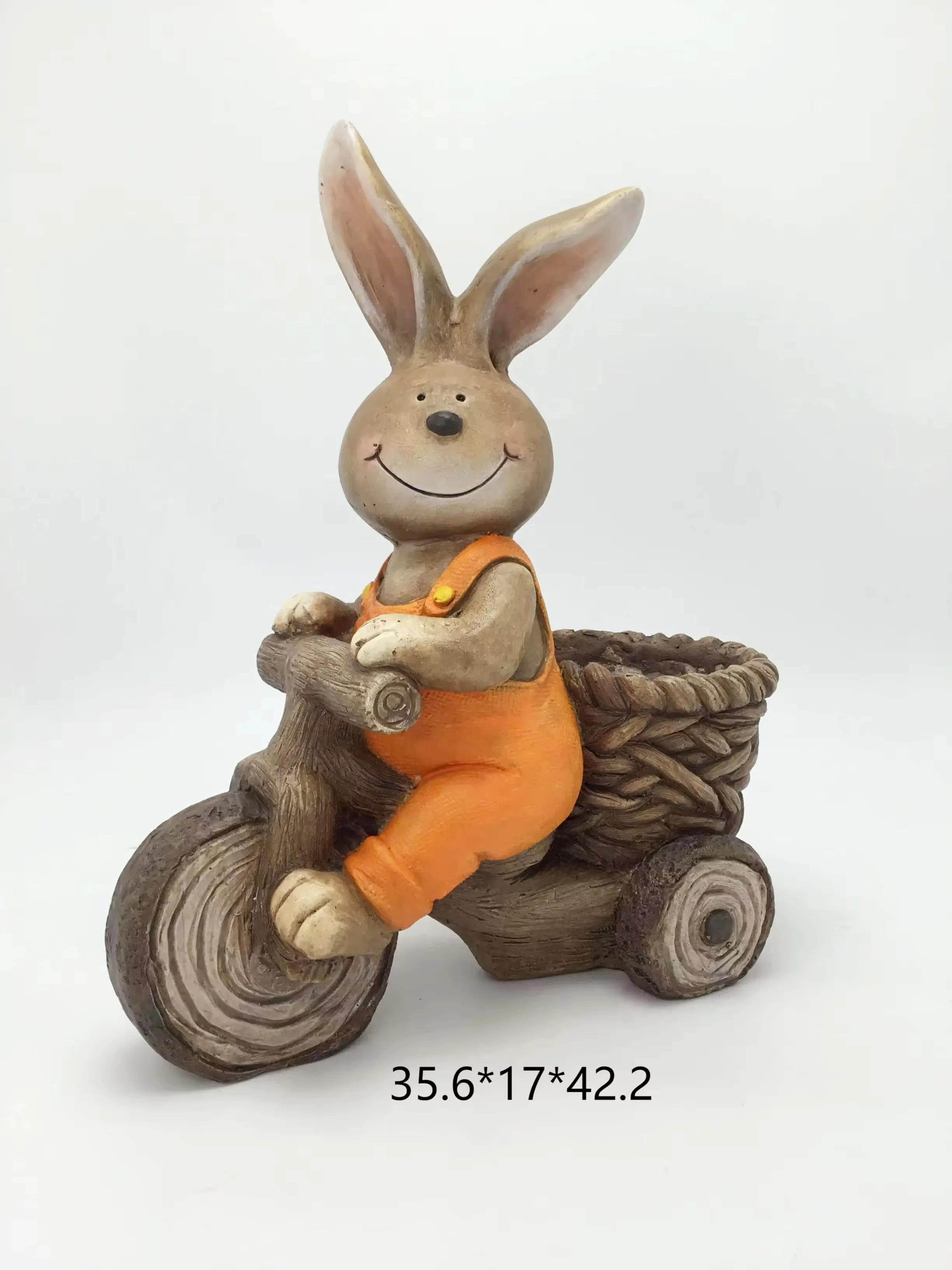Resin rabbit figurine riding a bicycle with a woven rear basket styled as a spring planter display