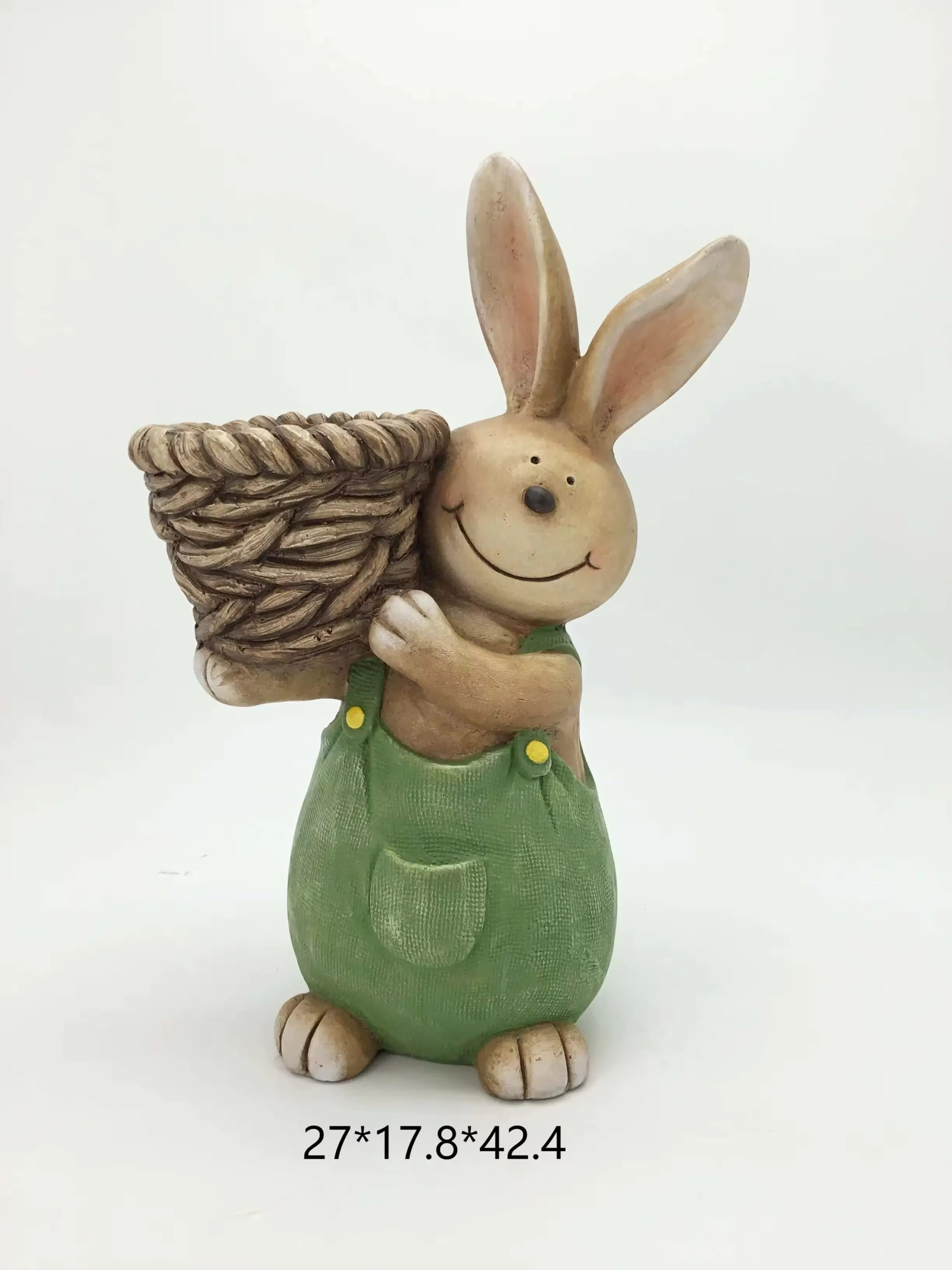 Resin rabbit in green overalls carrying a woven basket planter for spring garden decor