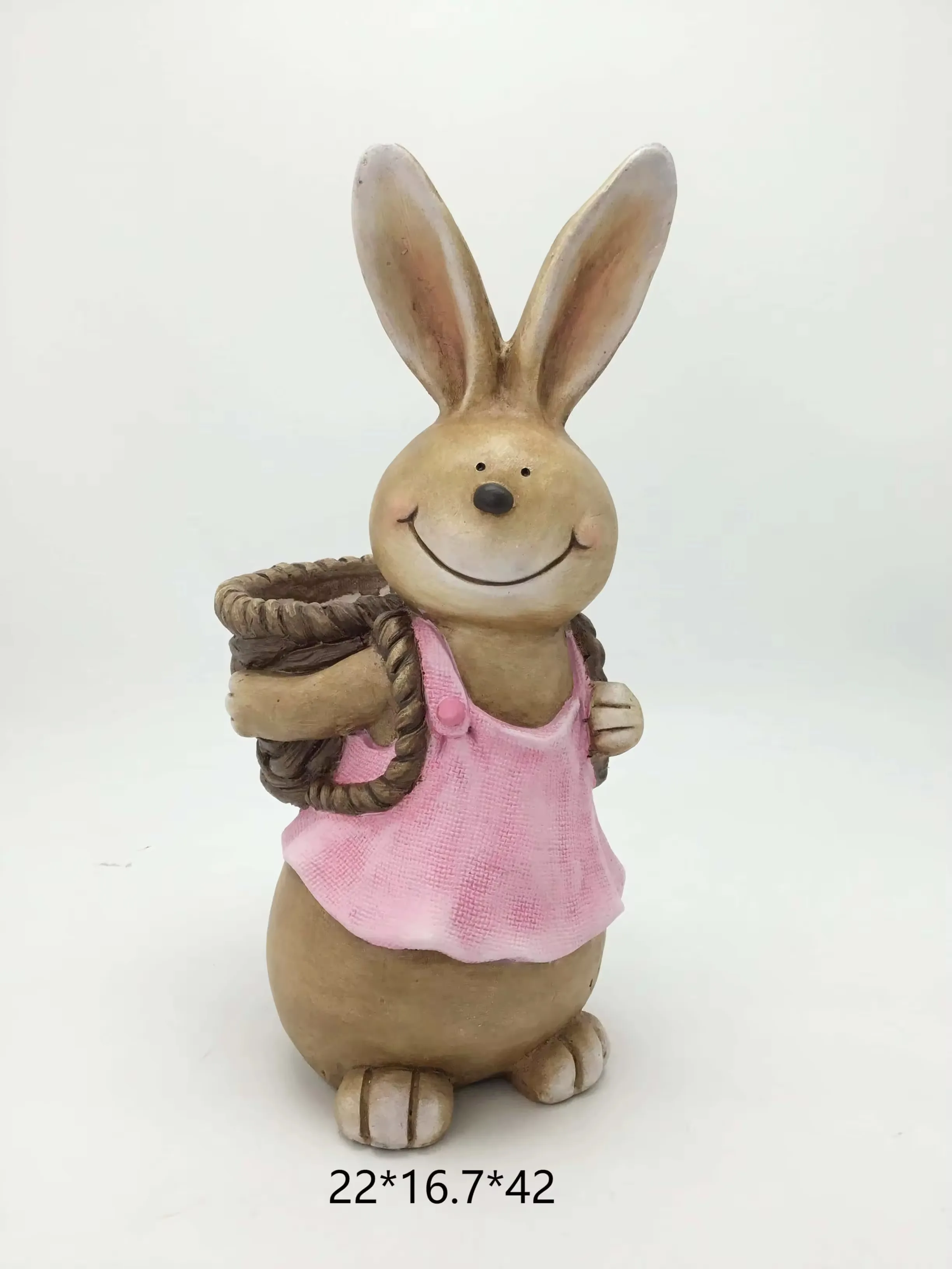 Resin rabbit figurine in a pink top carrying a basket on its back for spring home decor and Easter shelf displays
