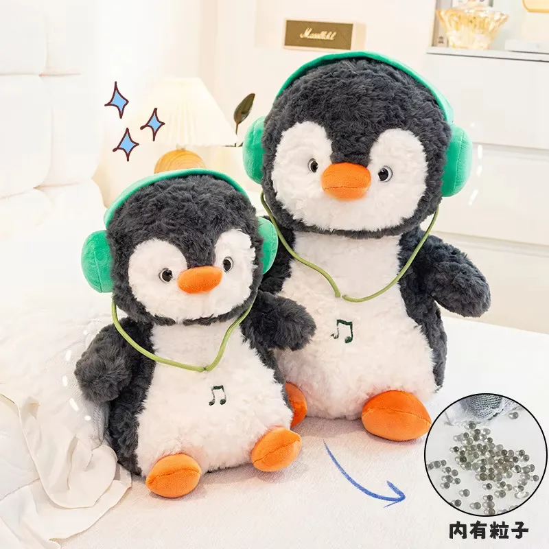 Two headphones penguin plush dolls displayed with a callout indicating bead filling inside the plush body