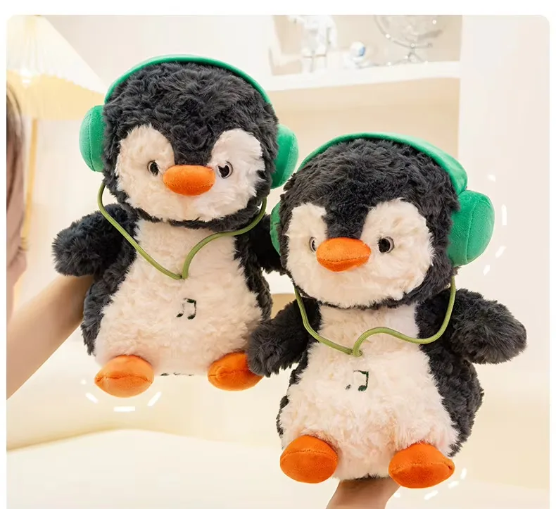 Two headphones penguin plush dolls held side by side to compare medium and large size options