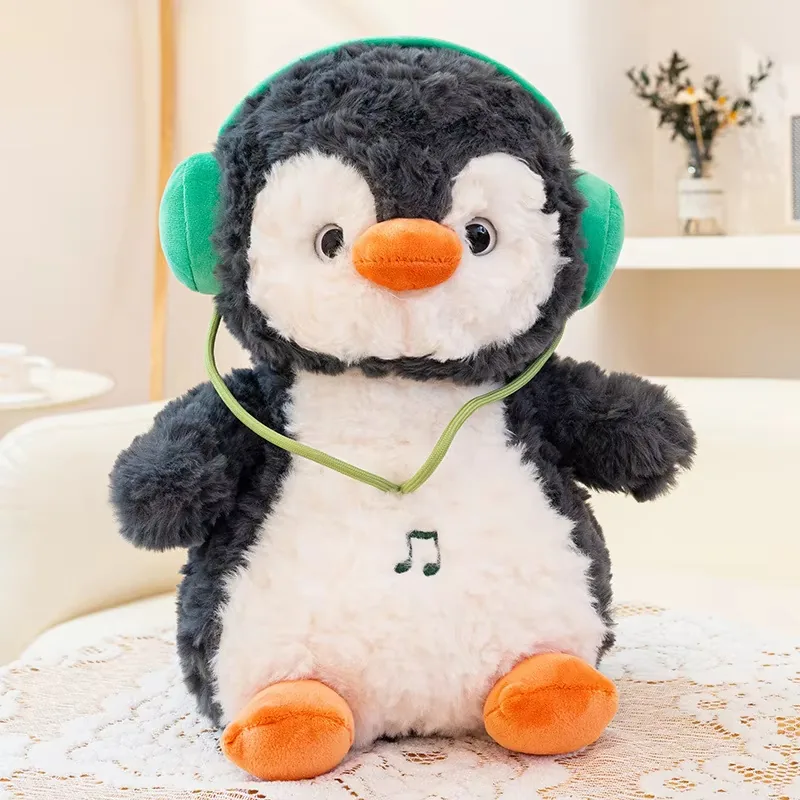 Single headphones penguin plush doll with soft charcoal fur, white belly, and orange beak and feet