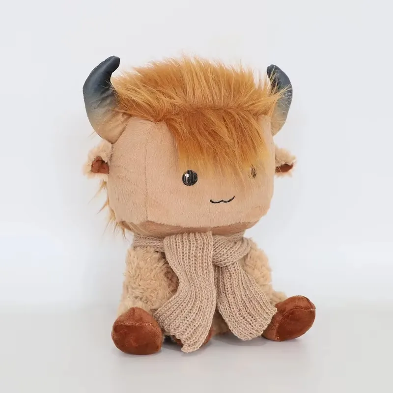 Highland cow plush doll in a three-quarter left angle with shaggy fringe partly covering one eye and scarf detail