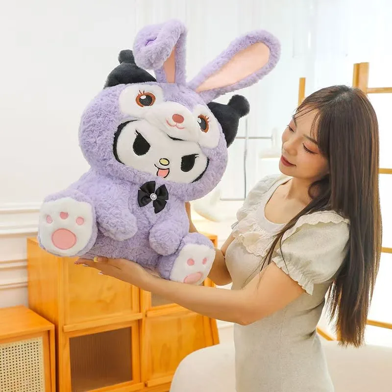 Woman holding a large purple Kuromi bunny plush toy to show scale