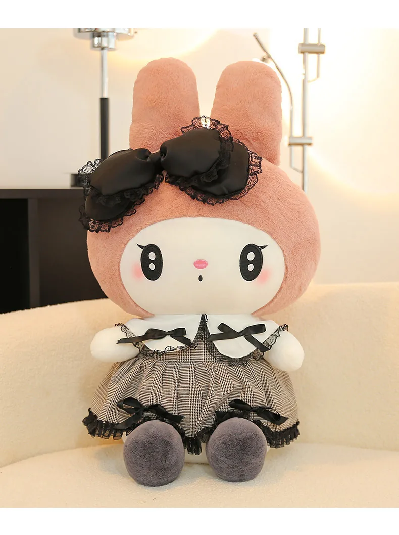 My Melody gothic princess plush doll seated on a sofa with a black lace bow and plaid dress