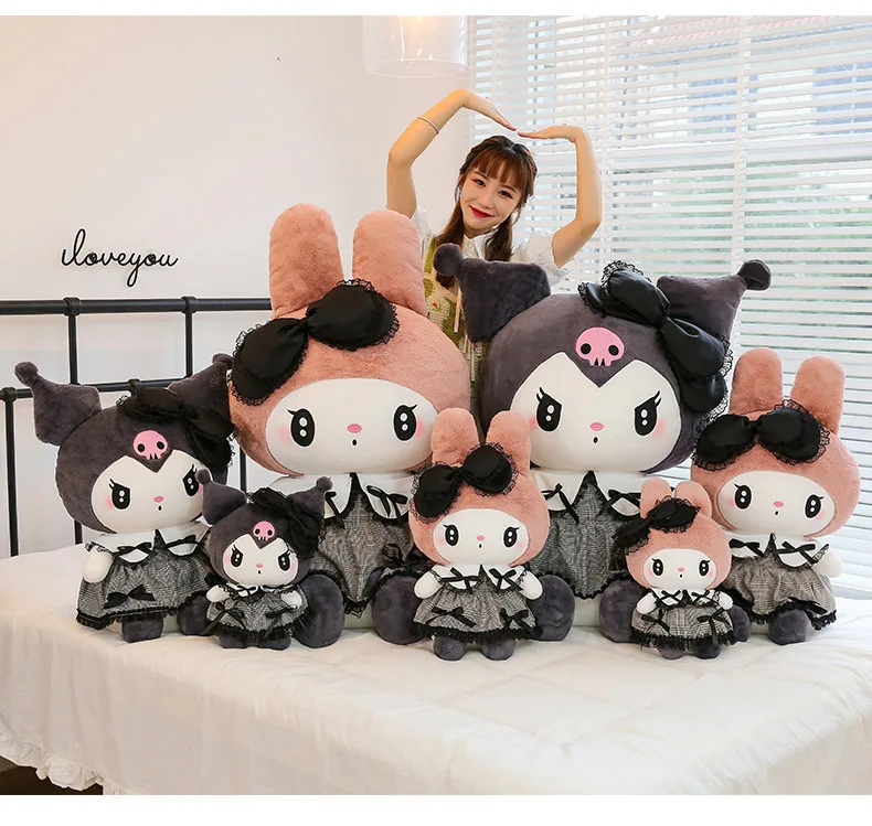 My Melody and Kuromi gothic plush collection with multiple sizes displayed beside a model on a bed