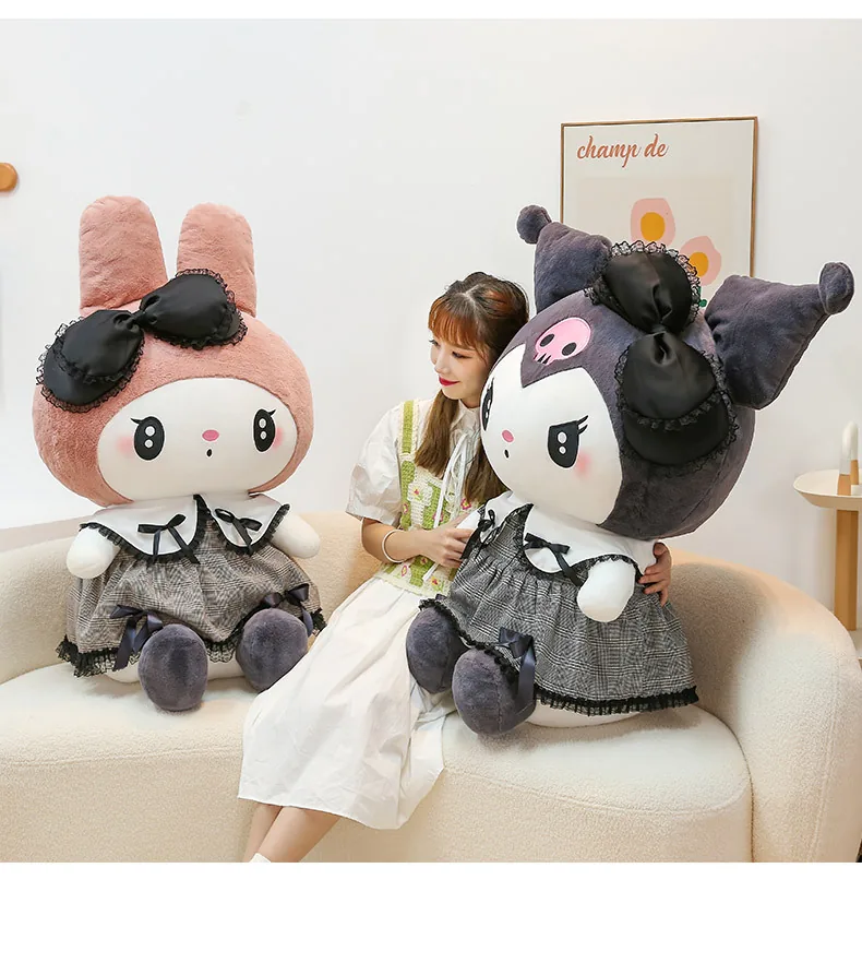Oversized My Melody and Kuromi gothic plush dolls displayed together on a sofa beside a model