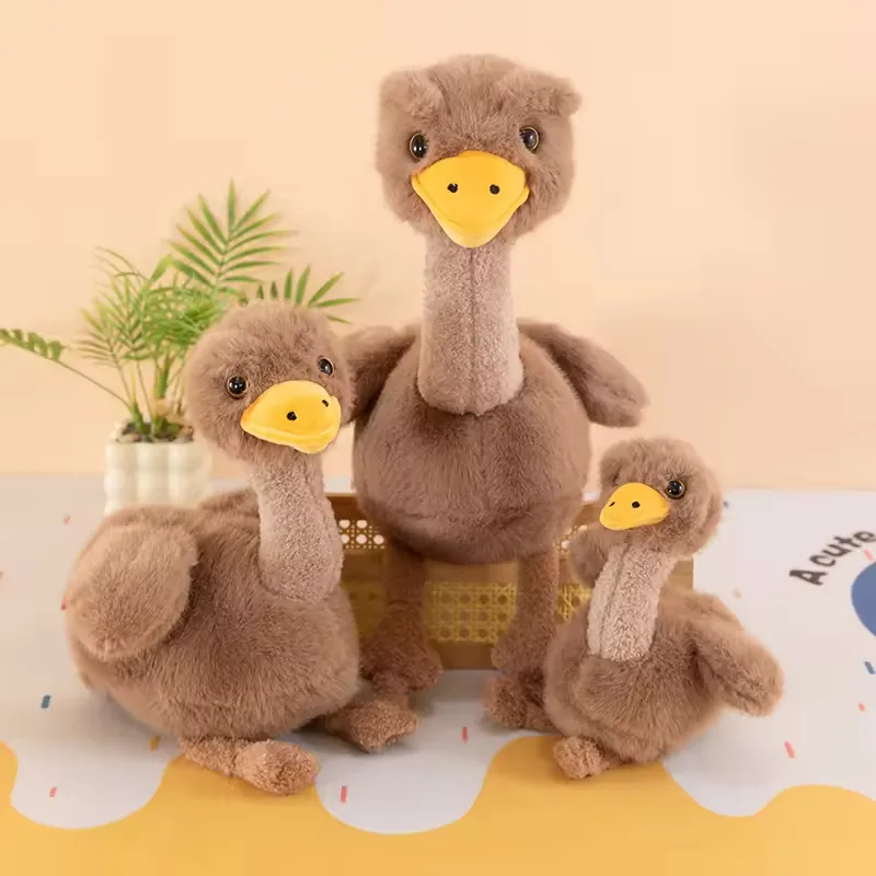 Three brown ostrich plush dolls displayed together in a size family with long necks, yellow beaks, and rounded bodies