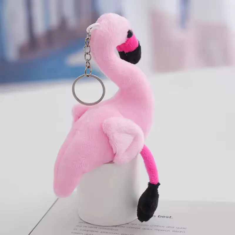 Light pink flamingo keychain plush charm hanging from a silver key ring