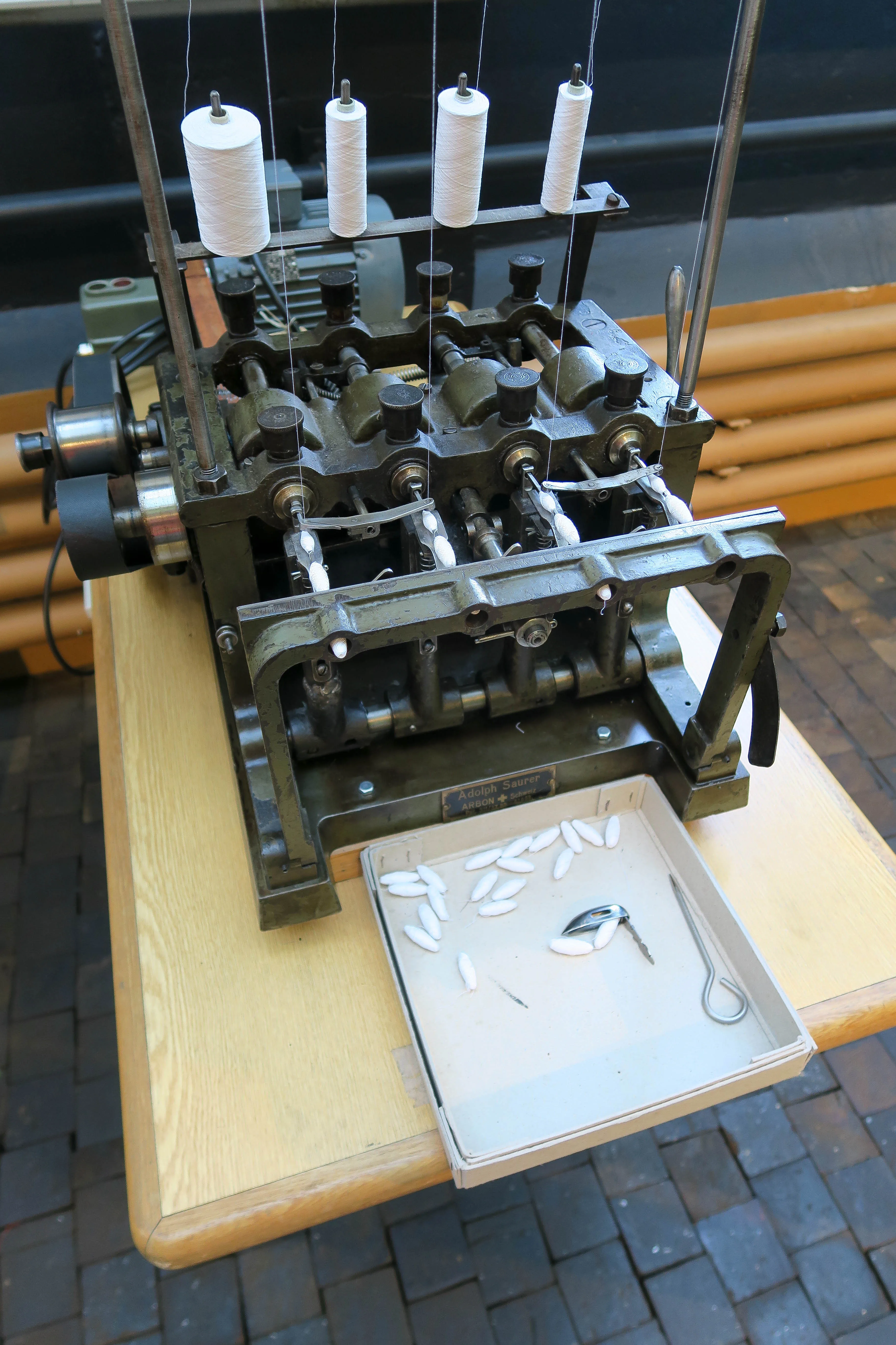 Embroidery machine with multiple bobbins and thread guides prepared for production