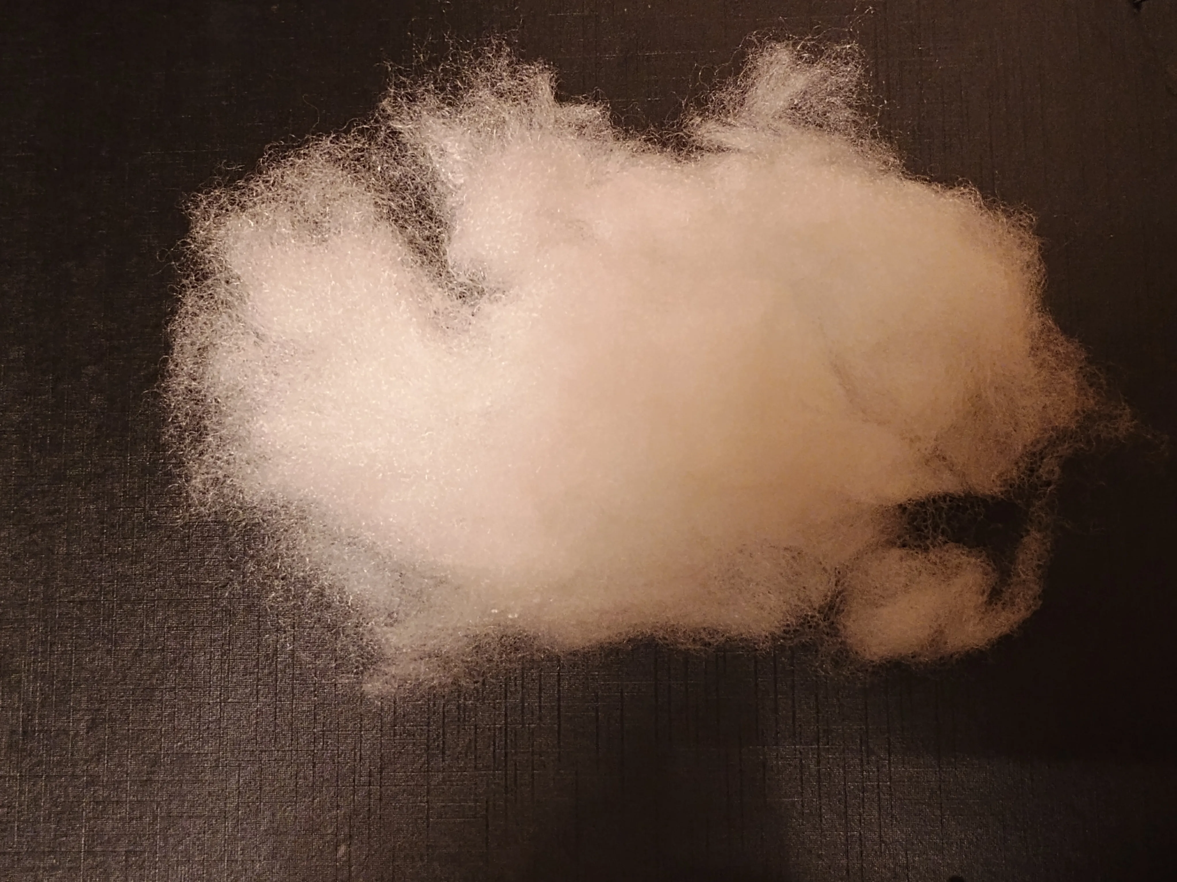 Loose white polyester fiberfill prepared for plush stuffing