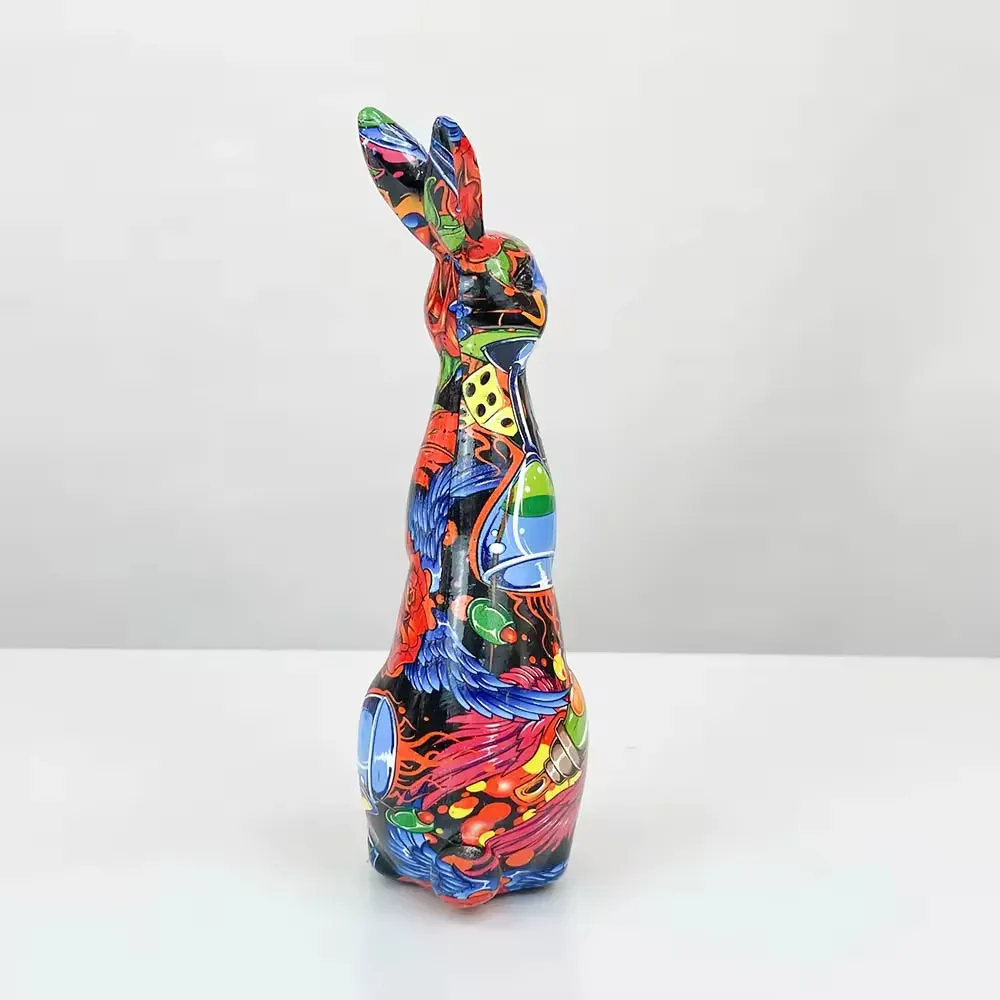 Left-side profile of a pop-art resin rabbit statue with layered bird, rose, and abstract graphic details