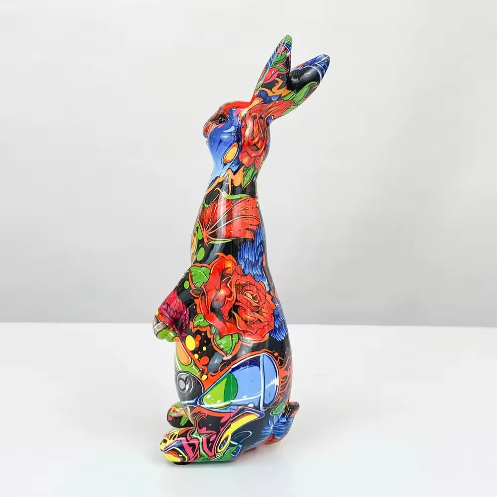 Right-front angle of a pop-art resin rabbit ornament with rose motifs, abstract graphics, and glossy finish