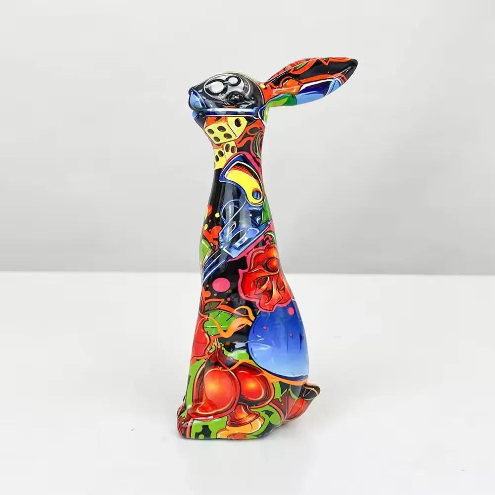 Right-side profile of a colorful resin rabbit desktop ornament with cherries, blue panels, and black gloss accents