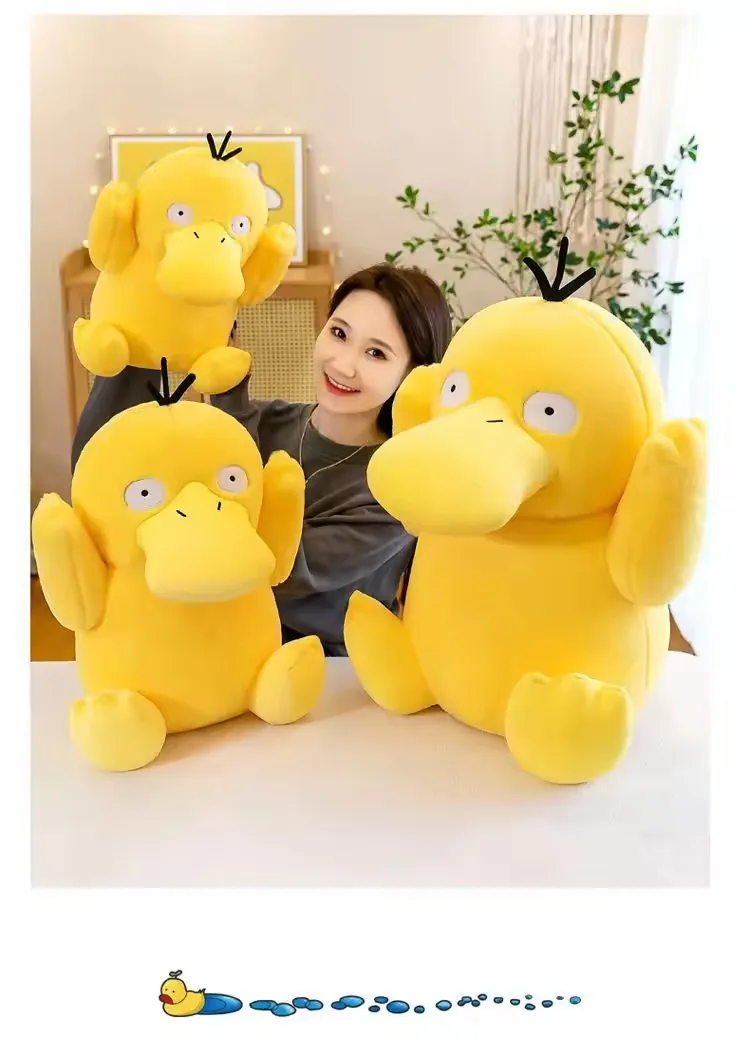Model surrounded by three Psyduck plush dolls in different sizes for assortment reference